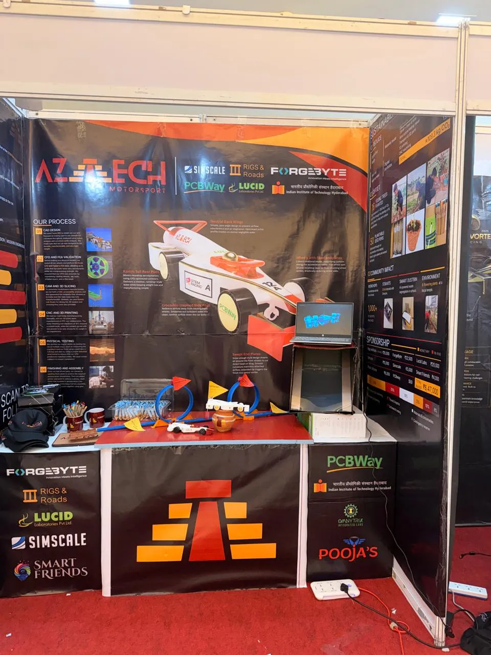 Aztech Motorsport's competition booth showing the car's design process, including physical testing